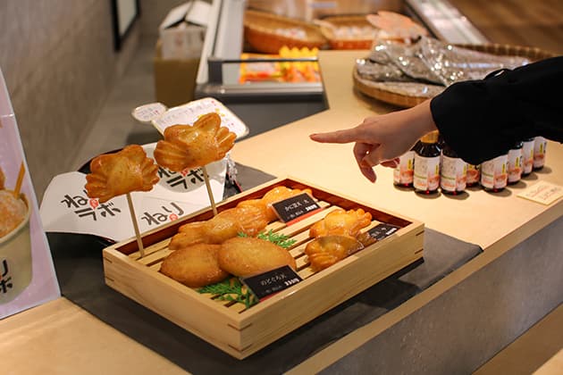 練屋・かまの穂、店頭のかまぼこ『練屋・かまの穂』は、かまぼこやちくわなどの「ねりもの」を製造販売。境港⽔産物直売センターにあるアンテナショップです。姿も風味もカニそのものの「姿かまぼこ」や紅ズワイガニを練り込んだ蒸しかまぼこなど、直売センターならではの味が勢ぞろい。揚げたてアツアツのすり身天ぷらがその場で楽しめる販売コーナーも。⿃取県境港市昭和町
