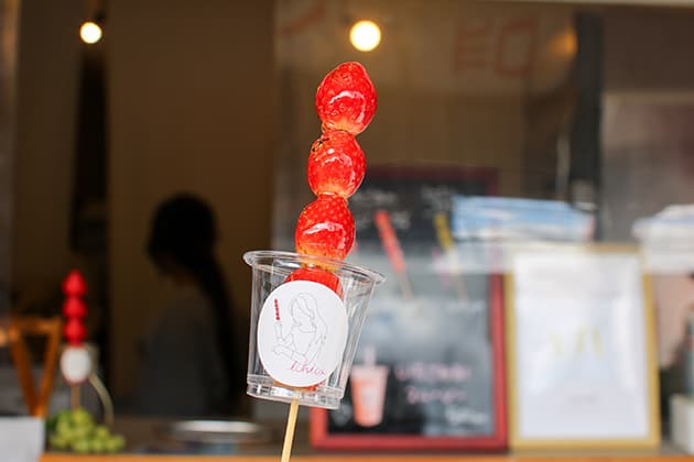 いちご飴専門店Ichica 『Ichica 』は山陰初の「いちご飴」専門店です。カリカリにコーティングした甘い飴とイチゴのほのかな酸味のバランスが絶妙な「いちご飴」は、鮮やかな色合いと串に5 つ連なっただんごスタイルのビジュアルも印象的です。イチゴのほかにも、リンゴやミカン、マスカットなど、季節ごとにさまざまなフルーツ飴が登場します。⿃取県境港市松ケ枝町